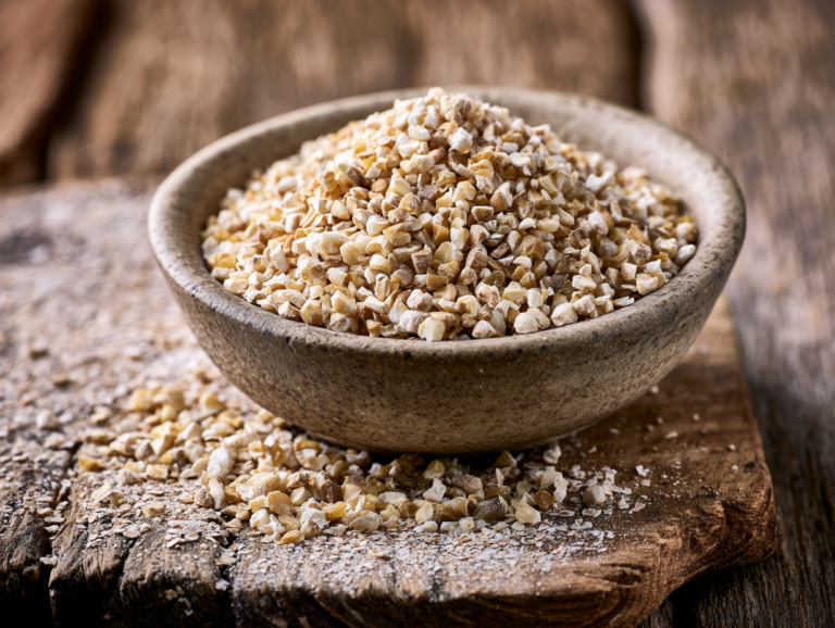 a bowl of steel-cut oats placed on a rustic wooden table, showcasing a hearty breakfast option